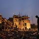 Soldiers stand in the rubble Friday, April 26, 2013, two days after a huge section of an eight-story building that housed several garment factories collapsed in Savar, near Dhaka, Bangladesh.